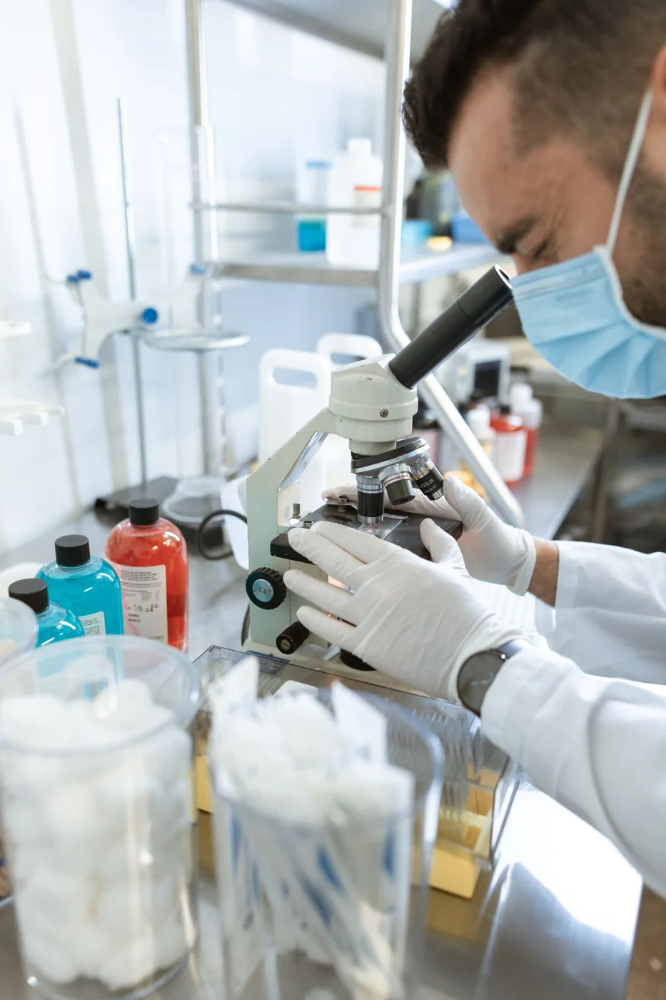 A researcher using a microscope